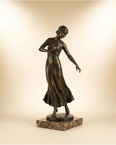 A bronze maquette for a standing figure with a dark brown patina on a slate base.