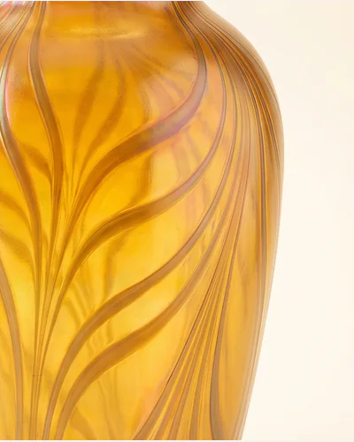 A studio glass vessel form with a reduced metallic surface, lit to show the iridescence. — the surface.