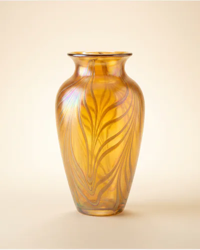 A studio glass vessel form with a reduced metallic surface, lit to show the iridescence.