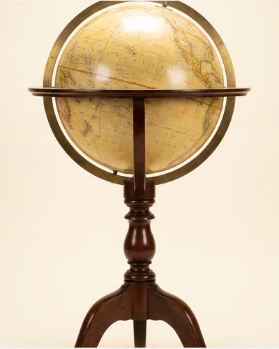 An antique terrestrial library globe on a mahogany tripod stand with a brass meridian ring. — the gores.
